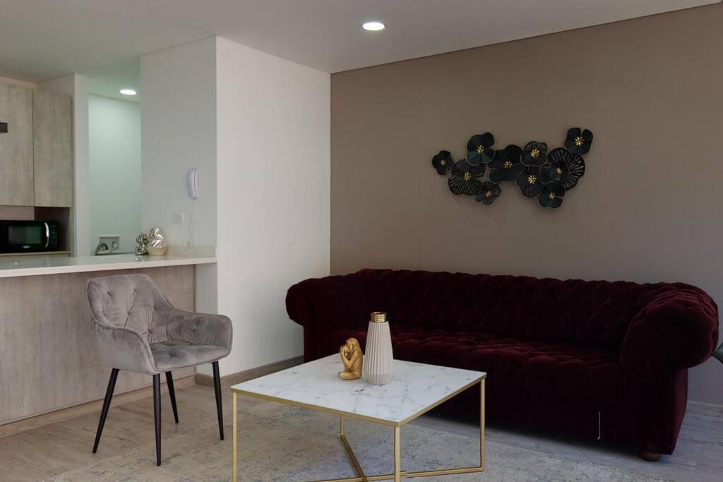 een woonkamer met een rode bank en een tafel bij Apartamento 201 Kappa in Bogota
