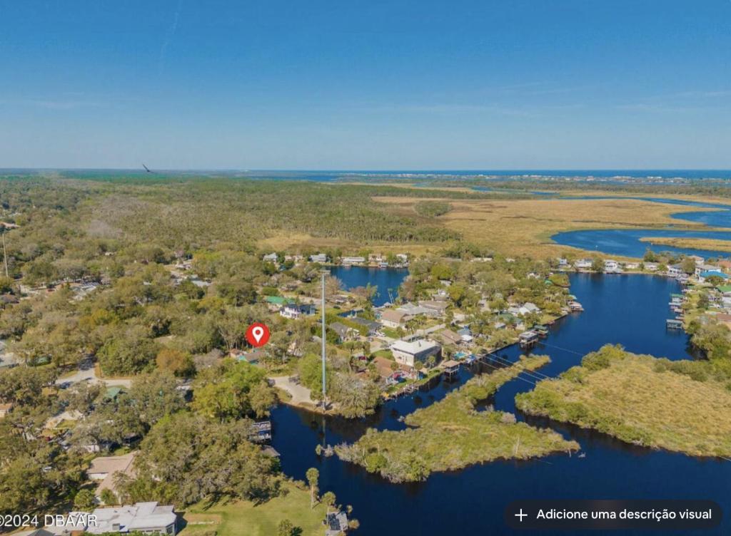 an aerial view of a home next to a body of water at Tomoka River Guest House in Ormond Beach