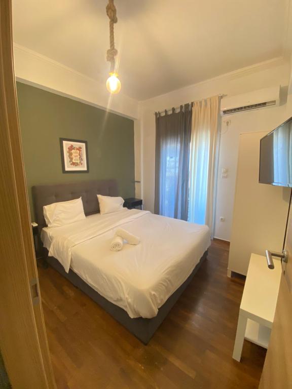 Łóżko lub łóżka w pokoju w obiekcie Athens City Themis 7