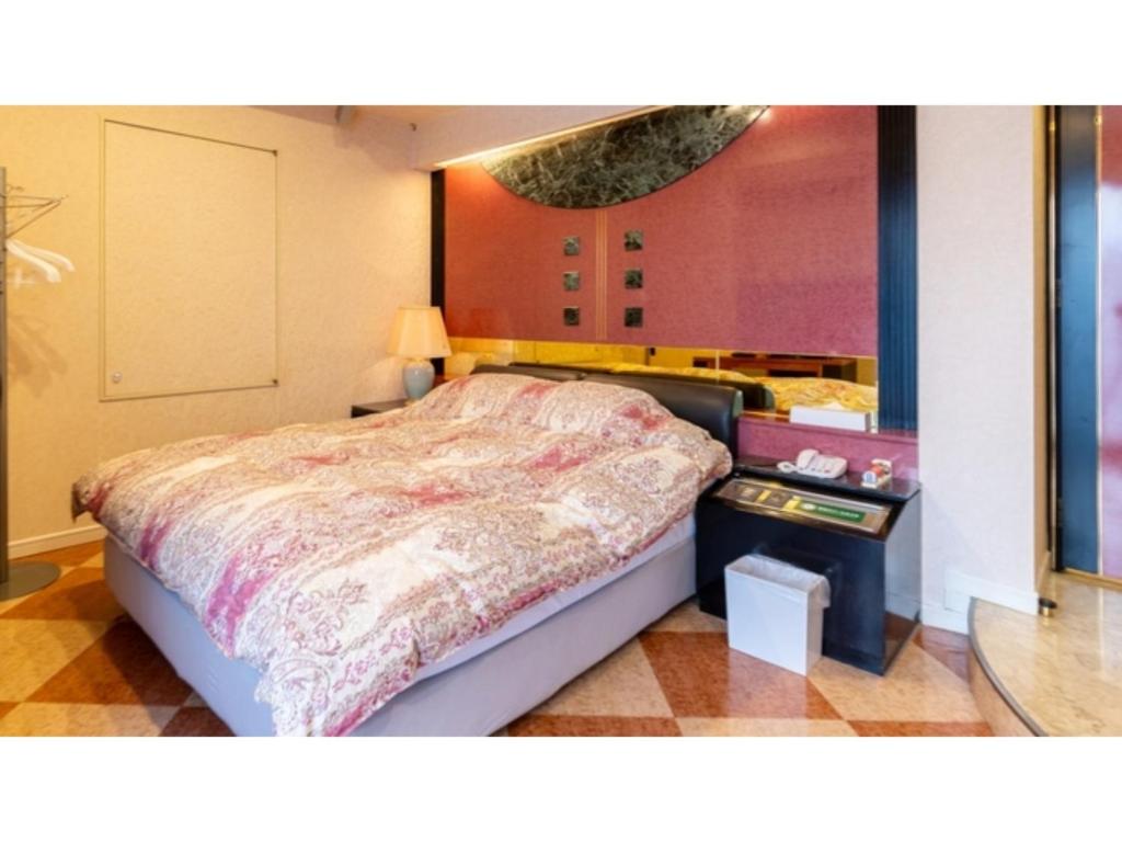 a bedroom with a bed and a table with a mirror at SHIZUKUISHI RESORT HOTEL - Vacation STAY 29476v in Shizukuishi