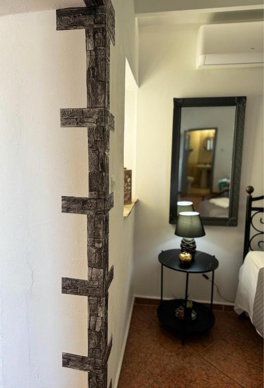a room with a wooden cross on the wall at O Mylos in Ermoupoli