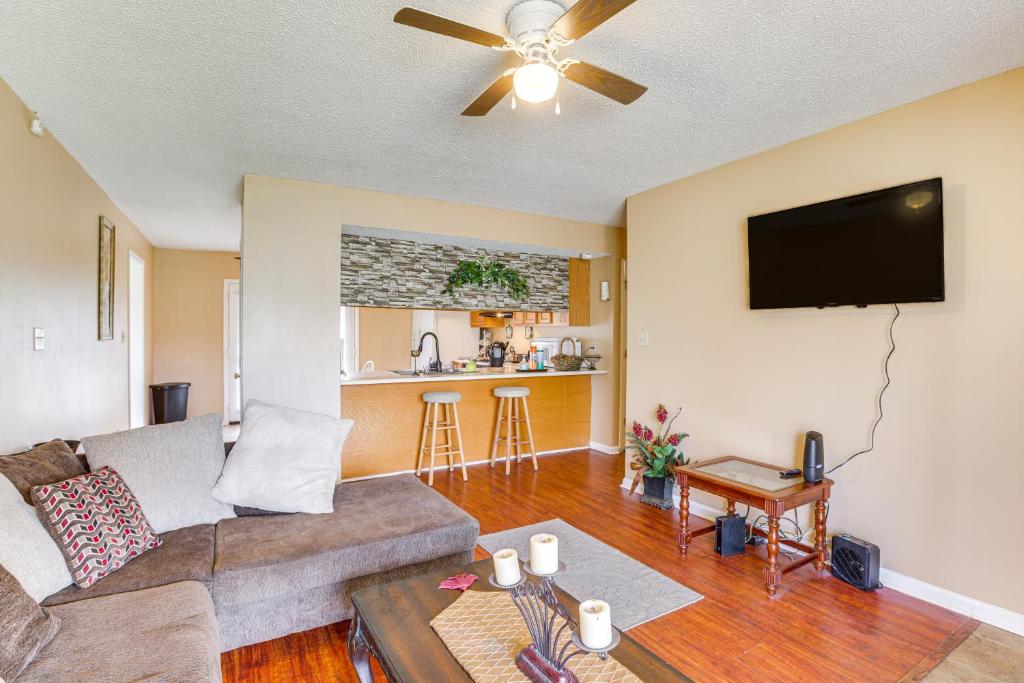 a living room with a couch and a flat screen tv at Cozy Family Retreat about 10 Mi to Downtown Birmingham in Brighton