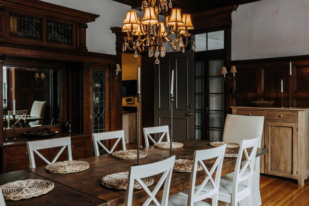 a dining room with a wooden table and white chairs at No. 5 East in Winnipeg