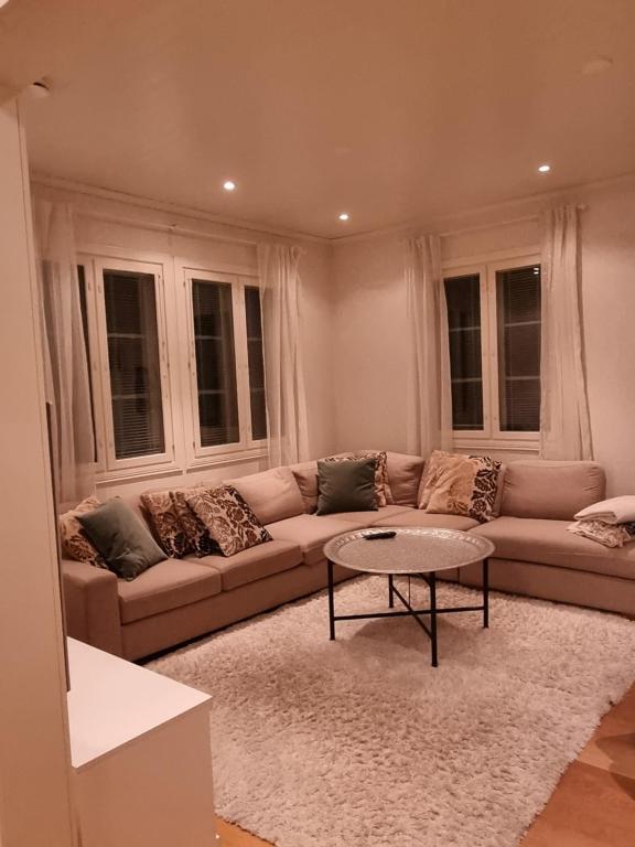 uma sala de estar com um sofá e uma mesa de centro em Beautiful townhouse, piece of luxury em Pori