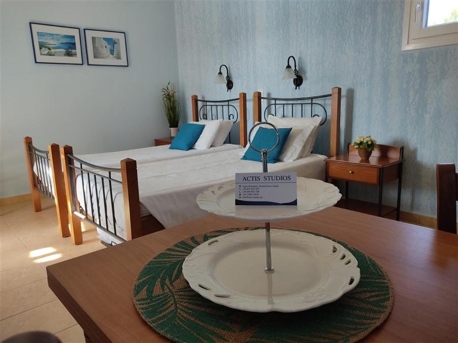 a room with two beds and a plate on a table at Actis studios 2 in Stelida