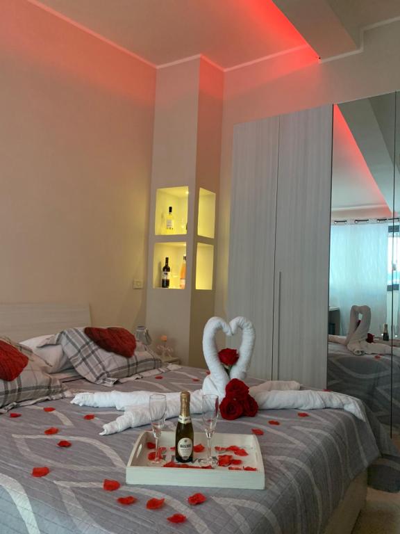 a room with a bed with a bottle of wine and a valentines heart at B&B La Penisola in Gragnano
