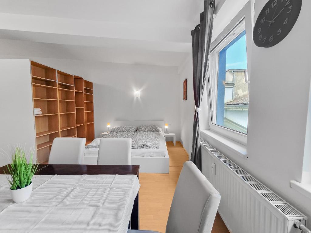 a room with two beds and a table and chairs at sparkasse platz 8 in Stockerau