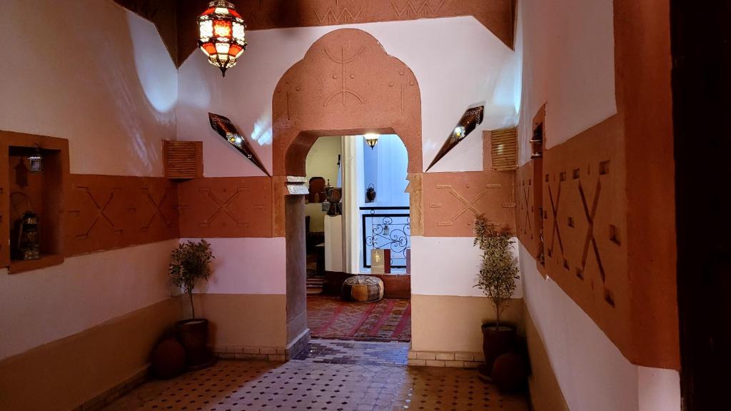a hallway with an archway in a house at Tafsut dades guesthouse stay with locals in Tamellalt
