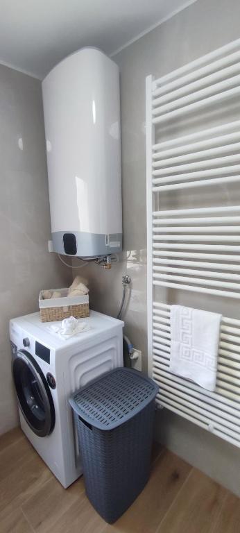a kitchen with a washing machine and a cabinet at Apartma Soča Oasis in Srpenica