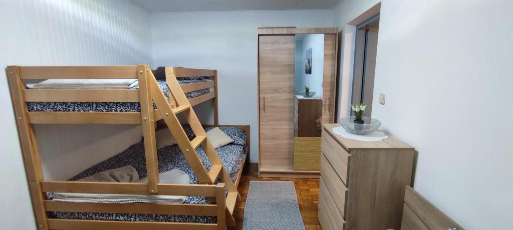 a room with two bunk beds and a mirror at Apartma Soča Oasis in Srpenica