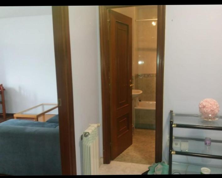 a bedroom with a door leading to a bathroom at PISO DEL PARQUE 2 in Santiago de Compostela