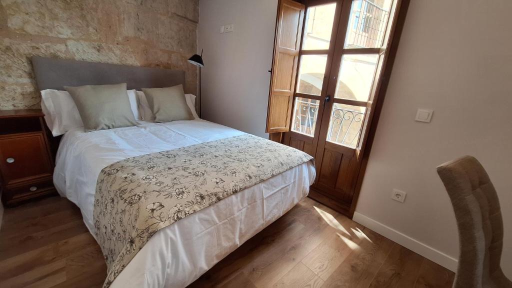 a bedroom with a bed and a large window at Poeta Iglesias 22 in Salamanca