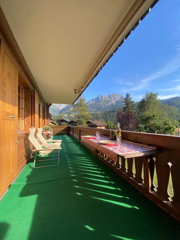 代堡Charming apartment with great view的阳台设有绿色地板和桌椅。