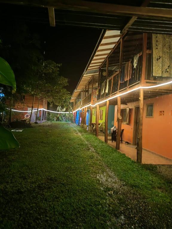 a building with lights on the side of it at night at Brisas del Caribe, casa 5 in Puerto Viejo