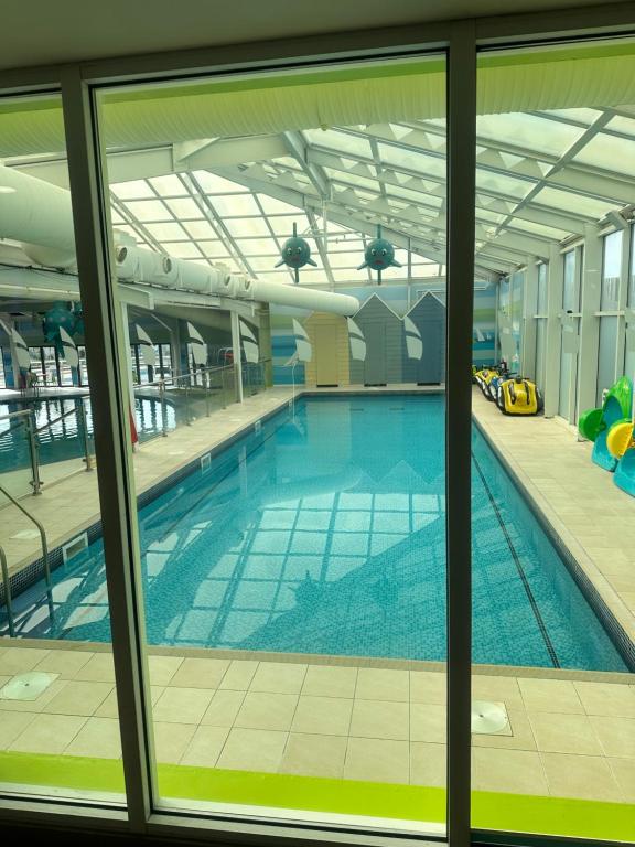a large swimming pool inside of a building at Serenity Coast in Wyke Regis