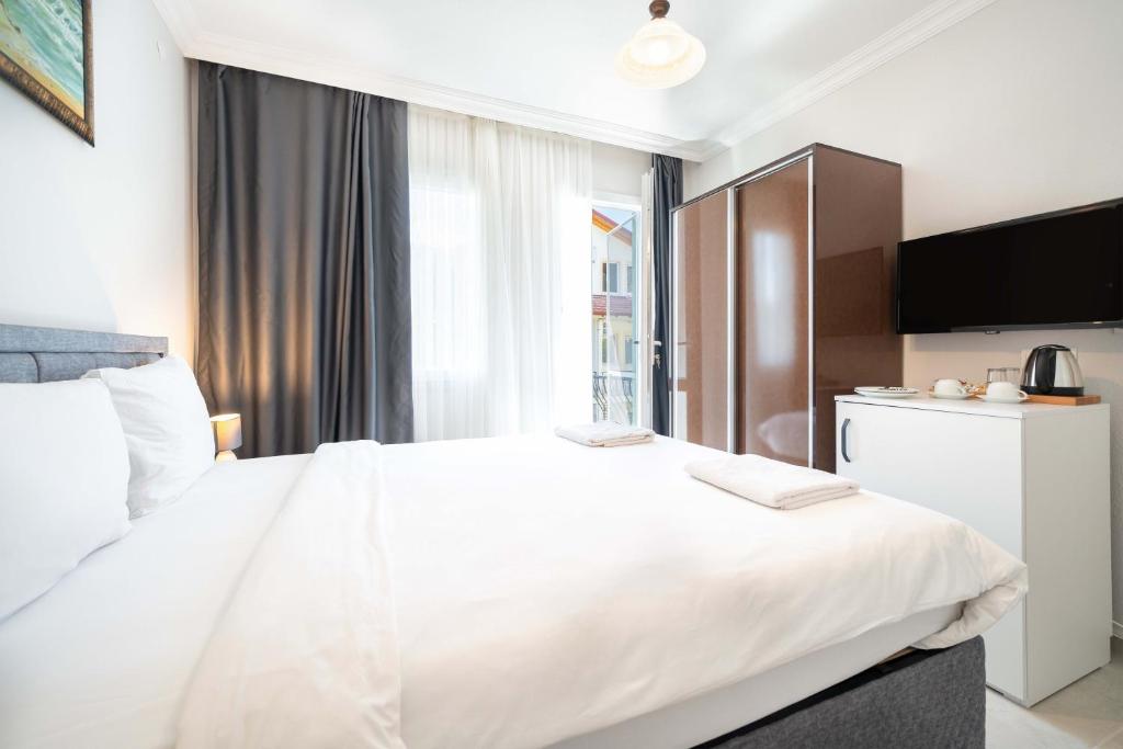 Postel nebo postele na pokoji v ubytování Dedeminn Garden Hotel