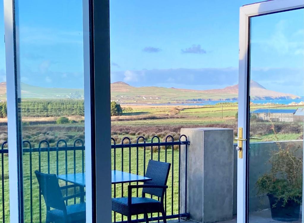a view from the balcony of a house with a table and chairs at Cille Apartments, Ballyferriter village in Ballyferriter
