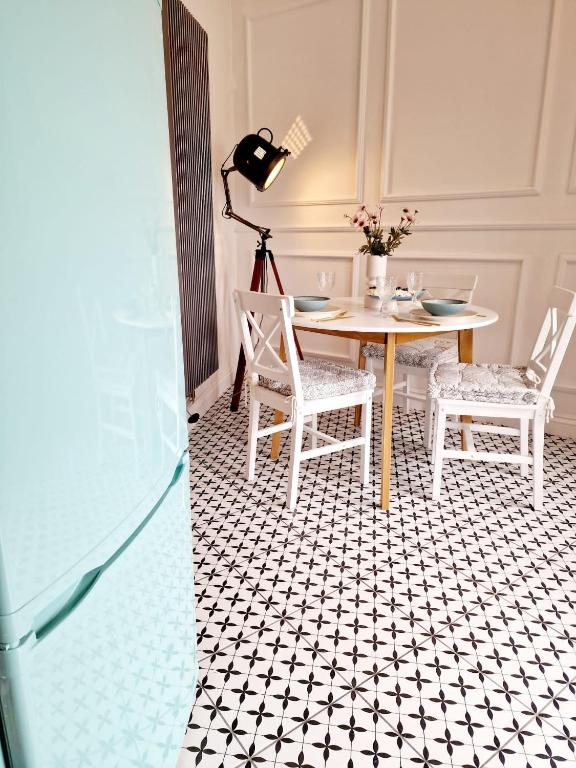 a dining room with a table and two chairs at Apartament Kety Rynek Mickiewicza in Kęty