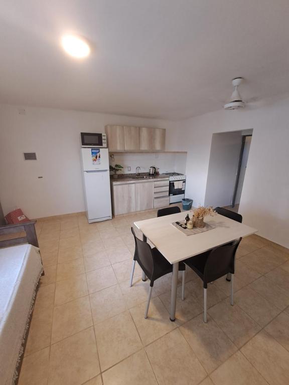 a kitchen with a table and chairs in a room at Departamento Alero in Goya