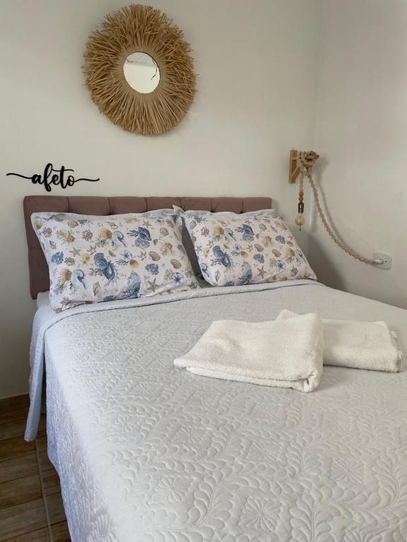 una camera da letto con un letto con due asciugamani sopra di Recanto do Mica a Governador Celso Ramos