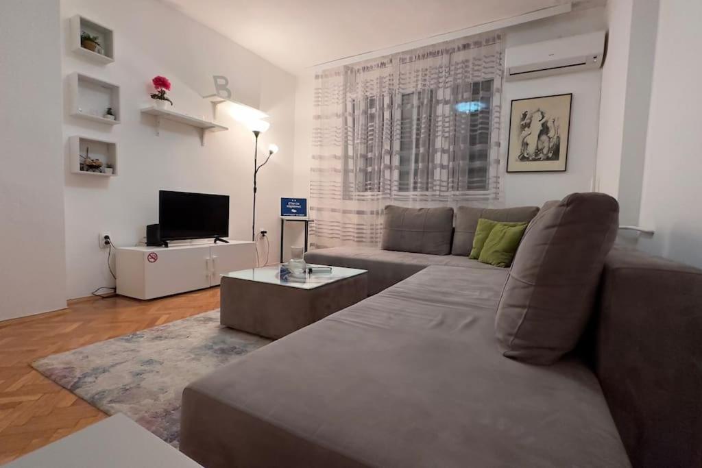 a living room with a couch and a television at Skopje 091 Macedonia st. in Skopje