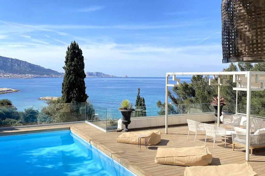 a swimming pool with a view of the ocean at Villa JFK in Marseille