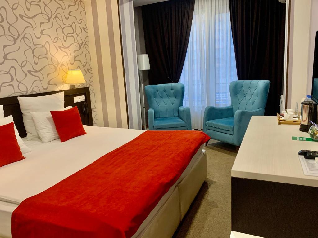 Postel nebo postele na pokoji v ubytování East Gate Boutique Hotel