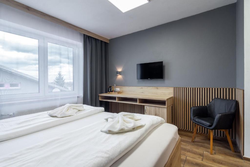 Postel nebo postele na pokoji v ubytování Hotel U Kociana