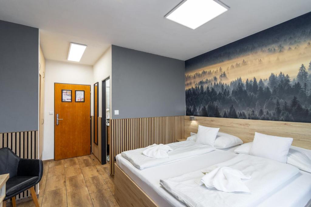 Postel nebo postele na pokoji v ubytování Hotel U Kociana