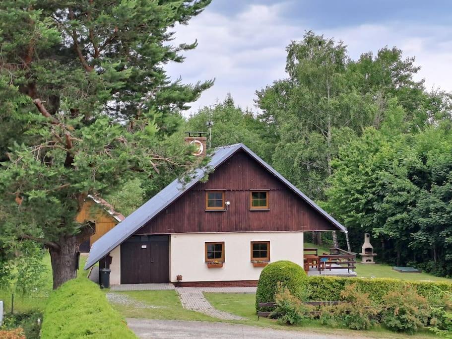 a brown and white barn with a gambrel roof at Chalupa František Filipovice in Filipovice