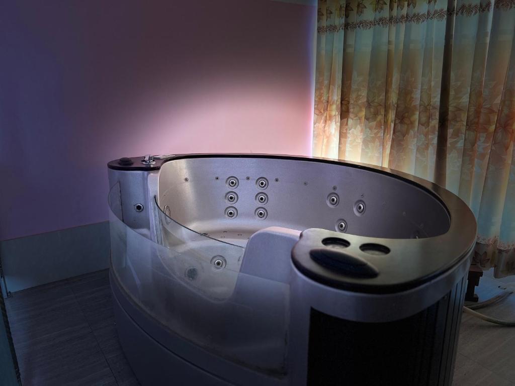 a bath tub with a face on it in a room at Nice Luxury Suites in Rājshāhi