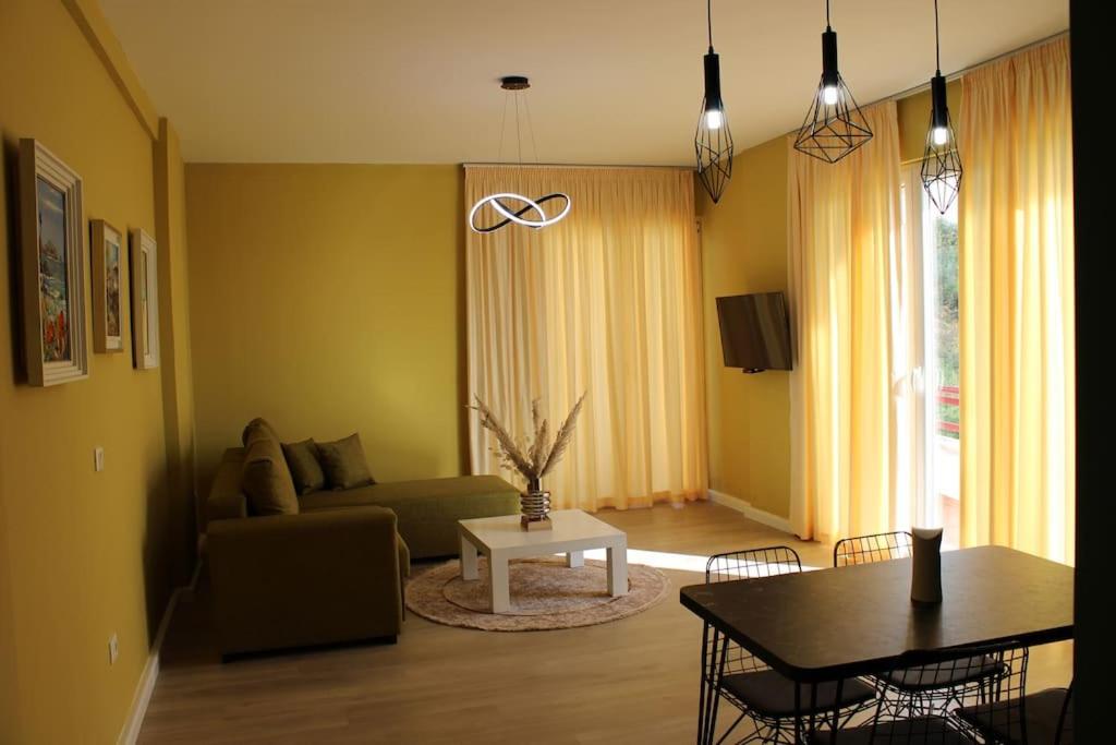 a living room with a couch and a table at Sunny Home overlooking Tirana in Tirana