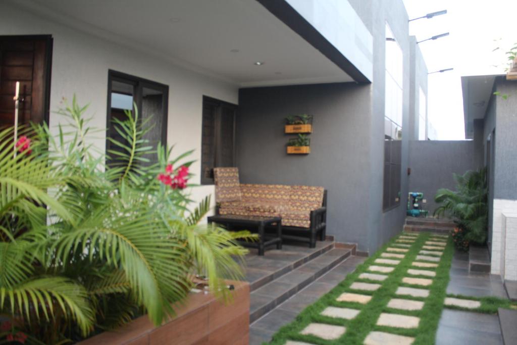 a patio with chairs and plants in a house at Libdo Immos in Cotonou