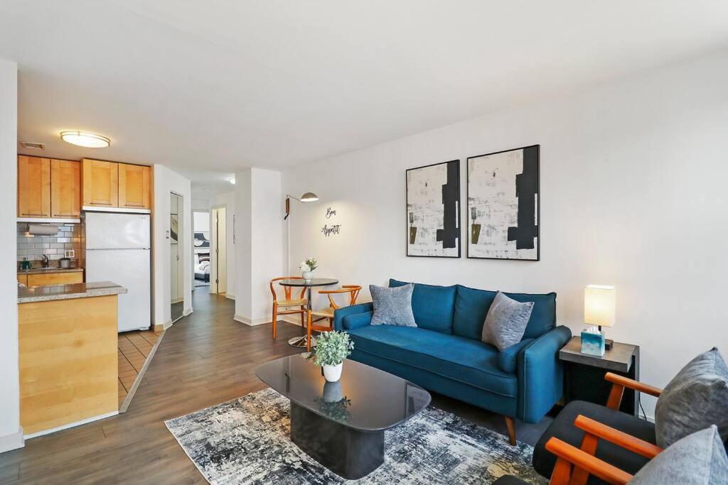 a living room with a blue couch and a table at Inviting 2-Bedroom Apt in Hyde Park - The Blackwood 0404 in Chicago