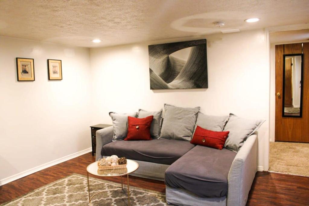 a living room with a couch and a table at 1 Bed Apt - Amazing Location 1 Block to Carson St in Pittsburgh