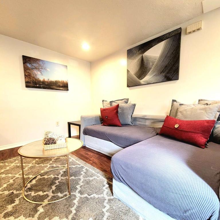 a living room with a couch and a table at 1 Bed Apt - Amazing Location 1 Block to Carson St in Pittsburgh