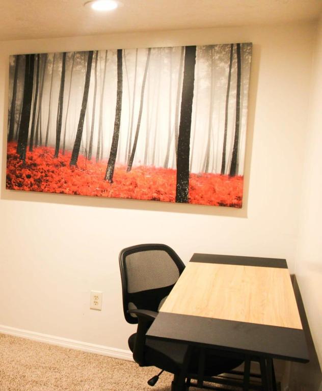 a table and a chair in a room with a painting at 1 Bed Apt - Amazing Location 1 Block to Carson St in Pittsburgh