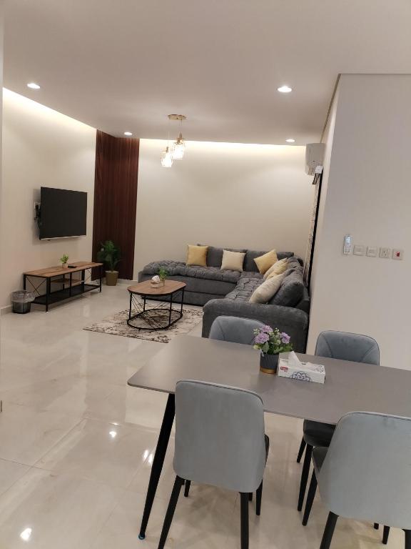 a living room with a couch and a table at شقق الياسمين in Medina