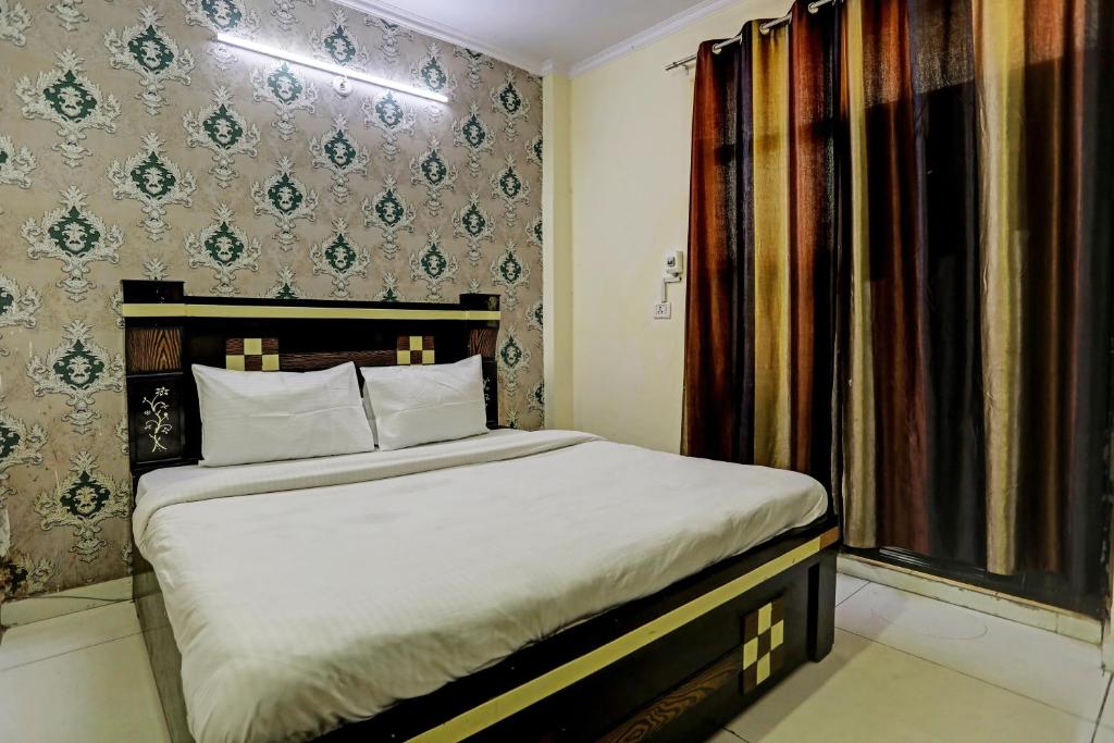 a bedroom with a bed and a window at Hotel Crystal INN in New Delhi