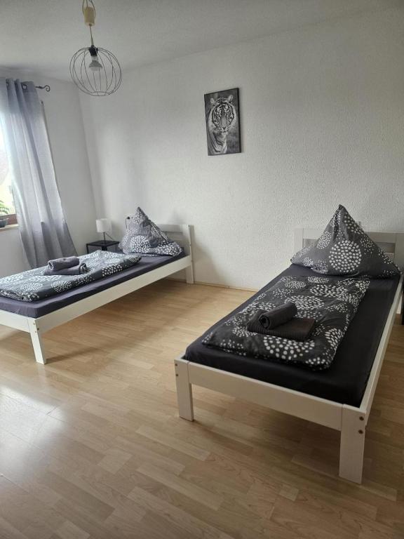 two beds are sitting in a room at PREMIUM HOME 2 in Gottmadingen