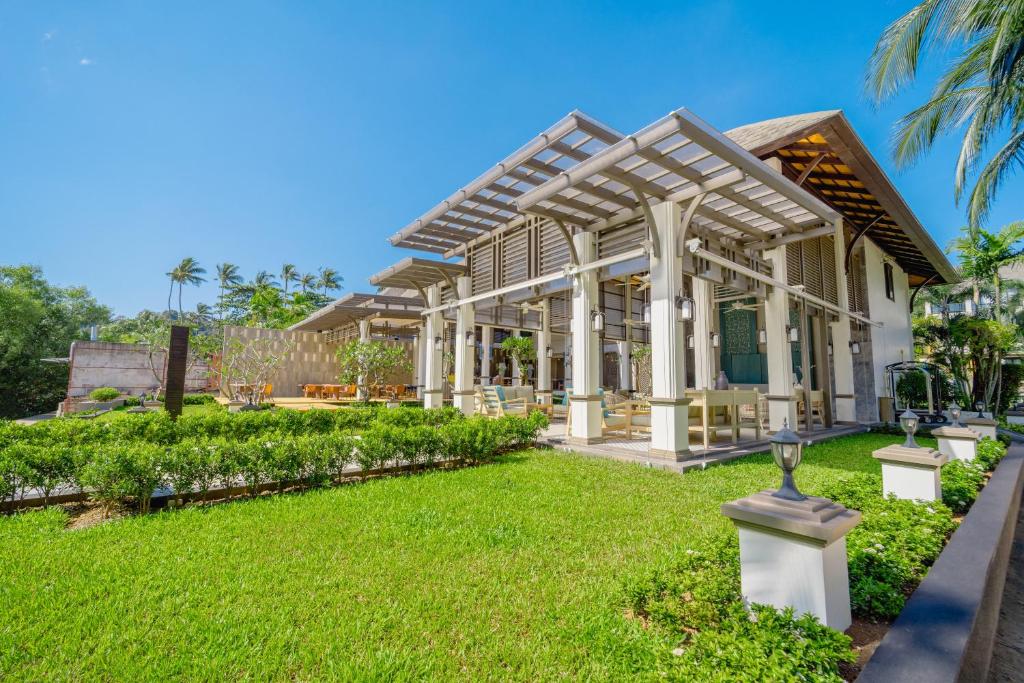 a house with a conservatory with a green yard at Bhu Nga Thani Resort & Villas Railay in Railay Beach