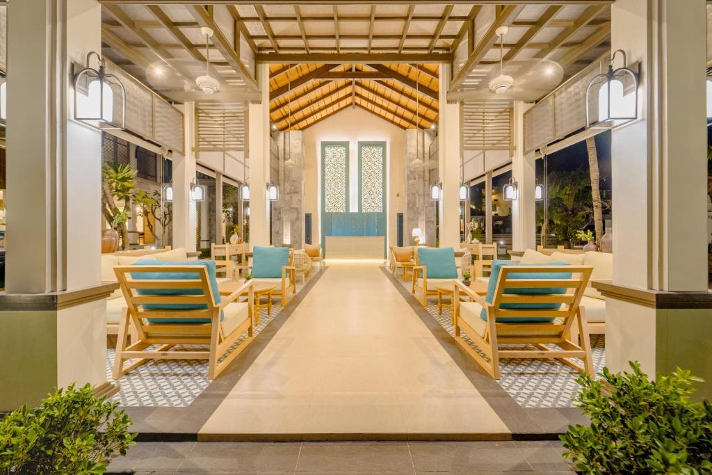 a hallway with chairs and tables in a building at Bhu Nga Thani Resort & Villas Railay in Railay Beach