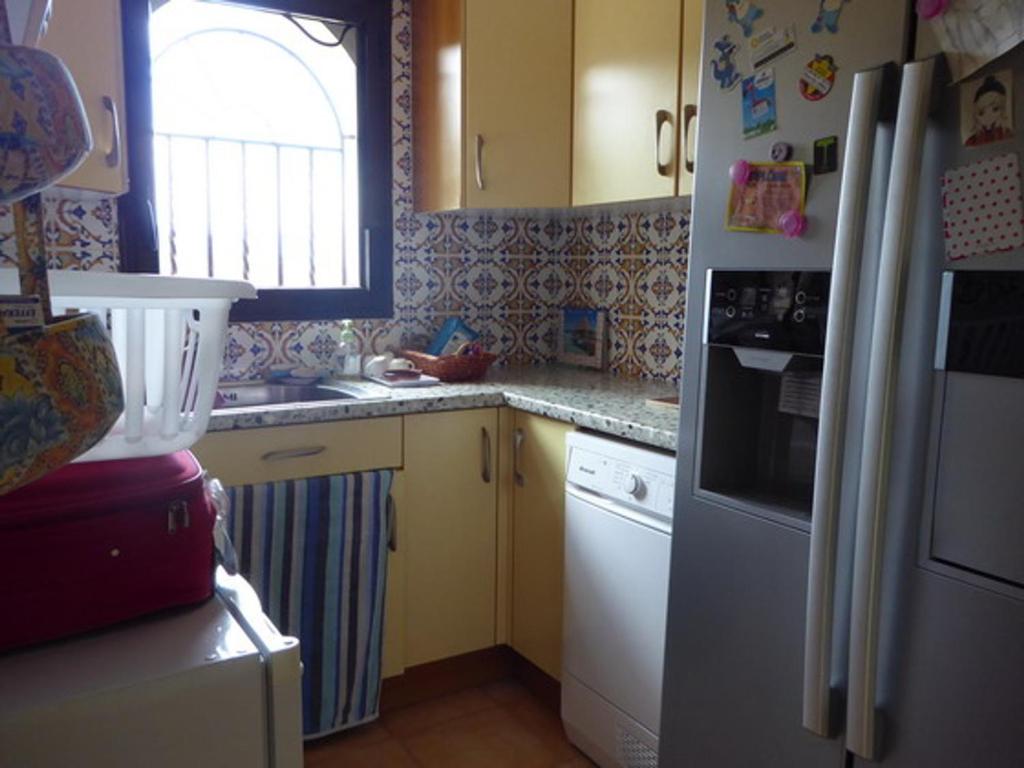 a kitchen with a white refrigerator and a window at Villa Sorède, 4 pièces, 6 personnes - FR-1-776-11 in Sorède