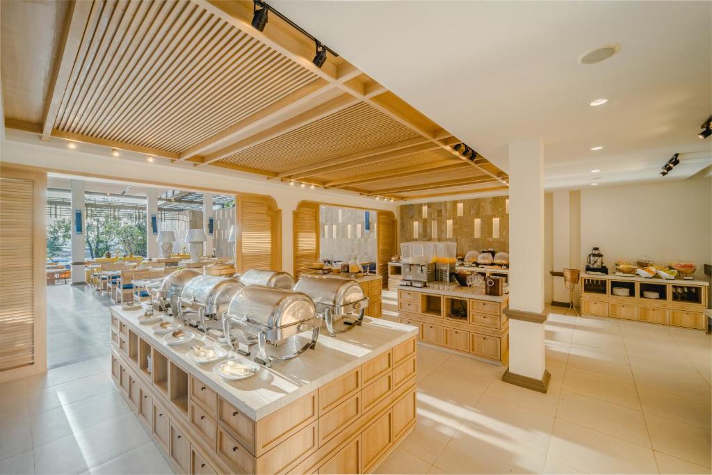 a large kitchen with a counter with many dishes at Bhu Nga Thani Resort & Villas Railay in Railay Beach