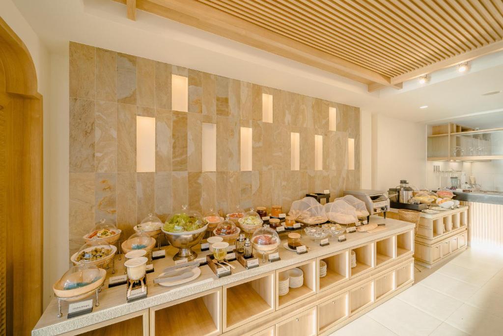 a kitchen with a buffet filled with food at Bhu Nga Thani Resort & Villas Railay in Railay Beach