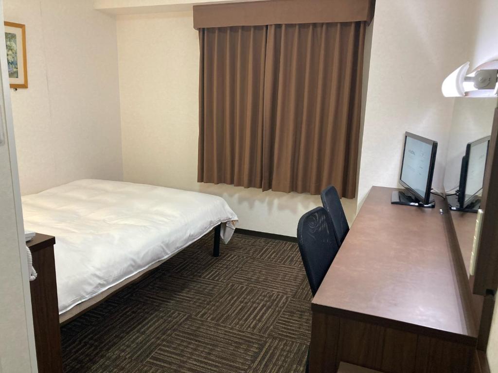 Postel nebo postele na pokoji v ubytování Hotel Alpha-One Tsuyama