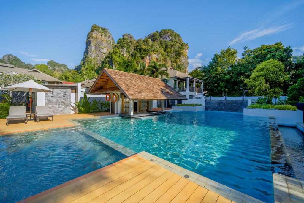 a swimming pool with a gazebo and a house at Bhu Nga Thani Resort & Villas Railay in Railay Beach