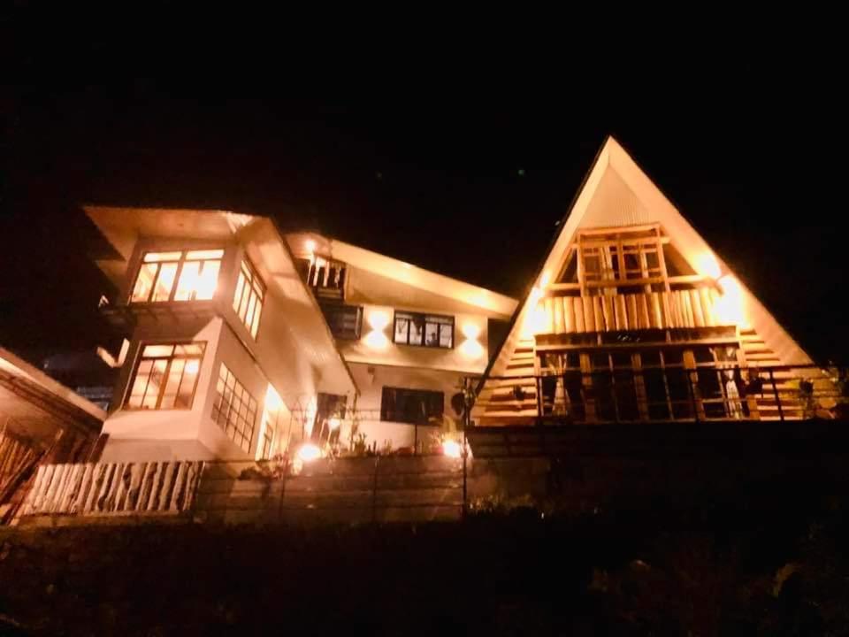 a large white house at night with lights at Zangmo Lee Baam Rezay gangtok Sikkim in Gangtok