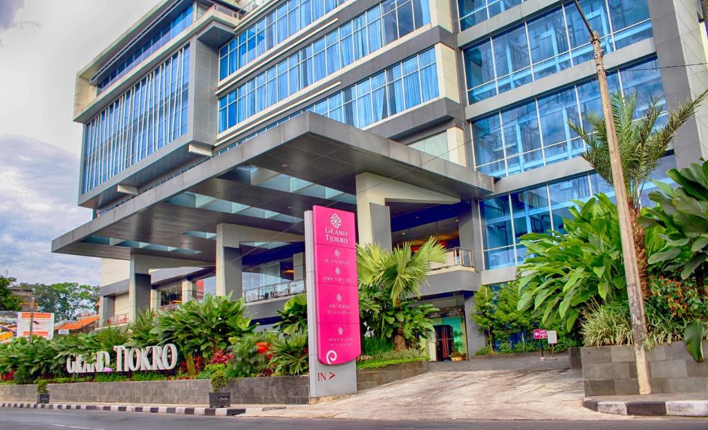 a building with a red sign in front of it at Grand Tjokro Premiere Bandung in Bandung