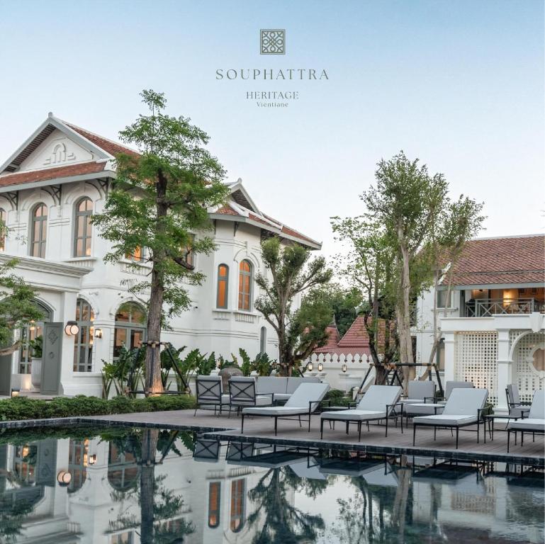 a villa with a pool in front of a building at SOUPHATTRA HERITAGE VIENTIANE in Vientiane